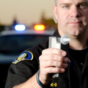 Police Officer Giving a Breathalyzer Breath Test