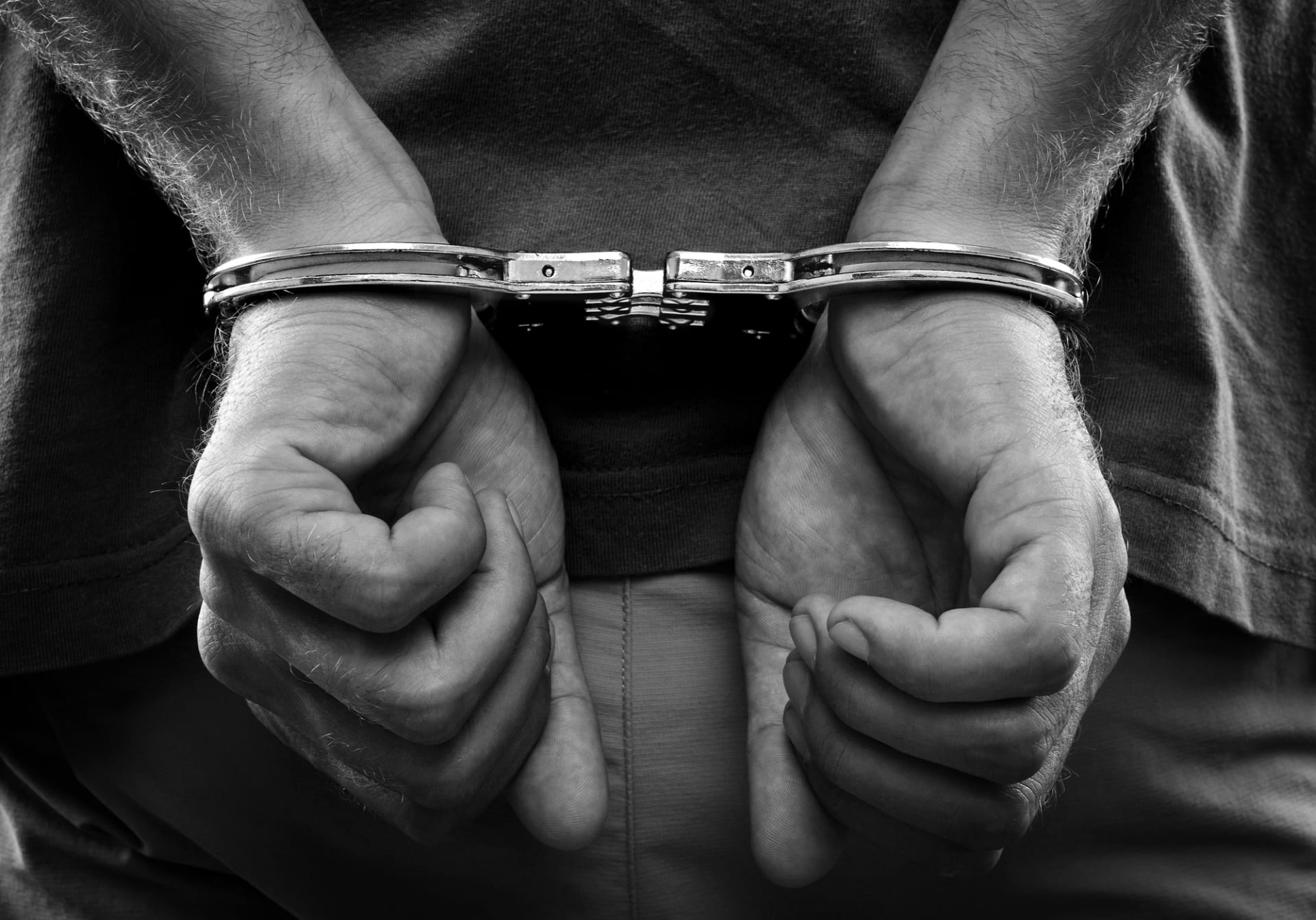 A person in handcuffs - Now It's Easier to Vacate a Conviction (including immigration convictions)