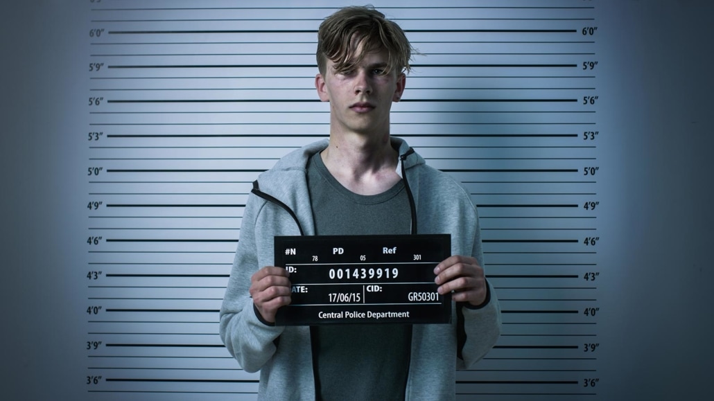 Juvenile defendant posing for a mugshot