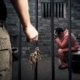Photo of a prison guard holding keys in front of an inmate's cell