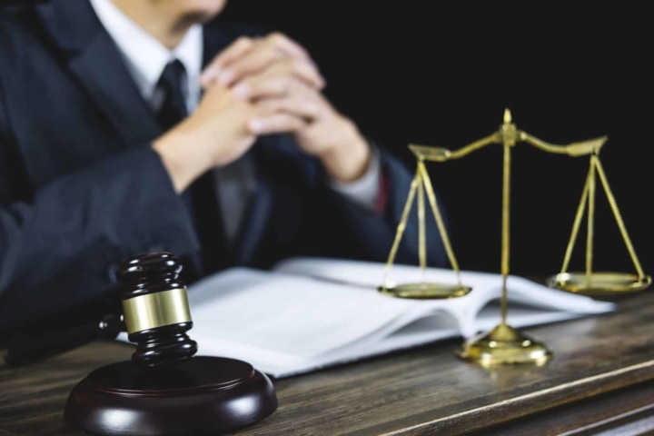 Male lawyer working in the courtroom sitting at the table